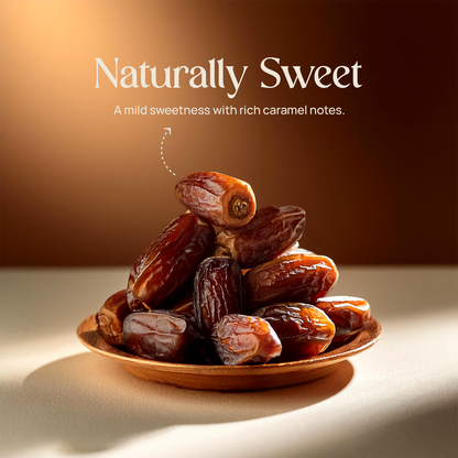 Pile of dark Arabian Mabroom dates in a small wooden bowl