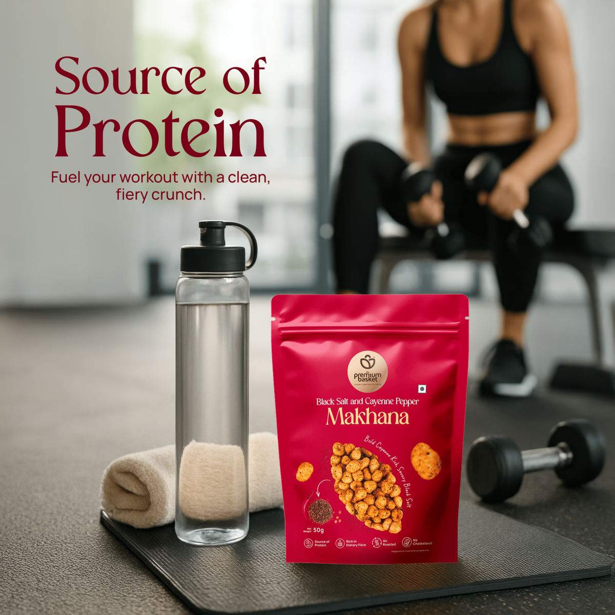 Red makhana snack pouch and water bottle on a gym floor mat