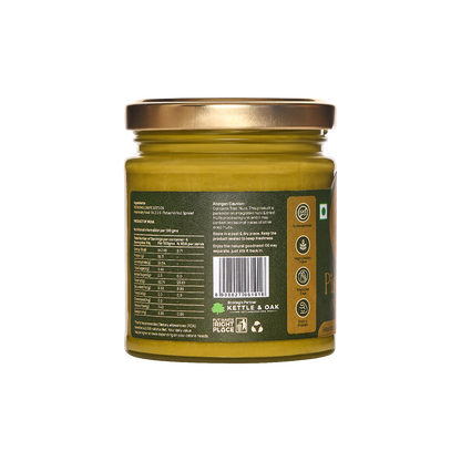 Pistachio nut butter jar with side label and nutrition panel on green glass