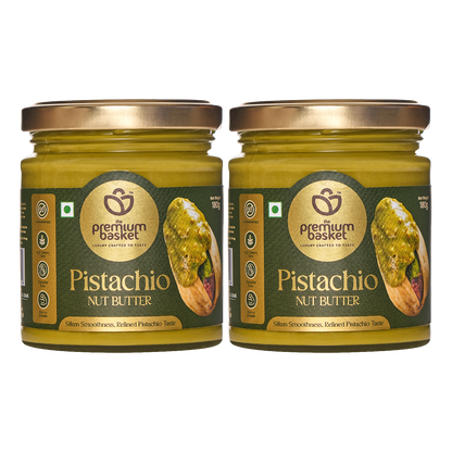 Two pistachio nut butter jars with green glass and gold lids, front labels